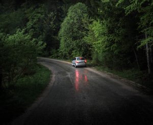 Car traveling along road at night
